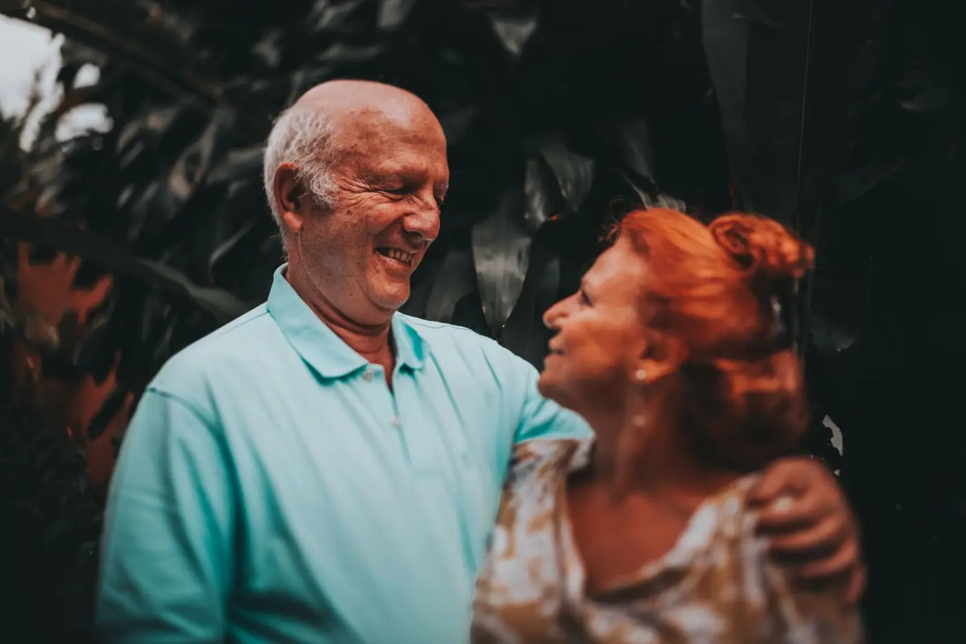 Smiling older couple embracing in a garden