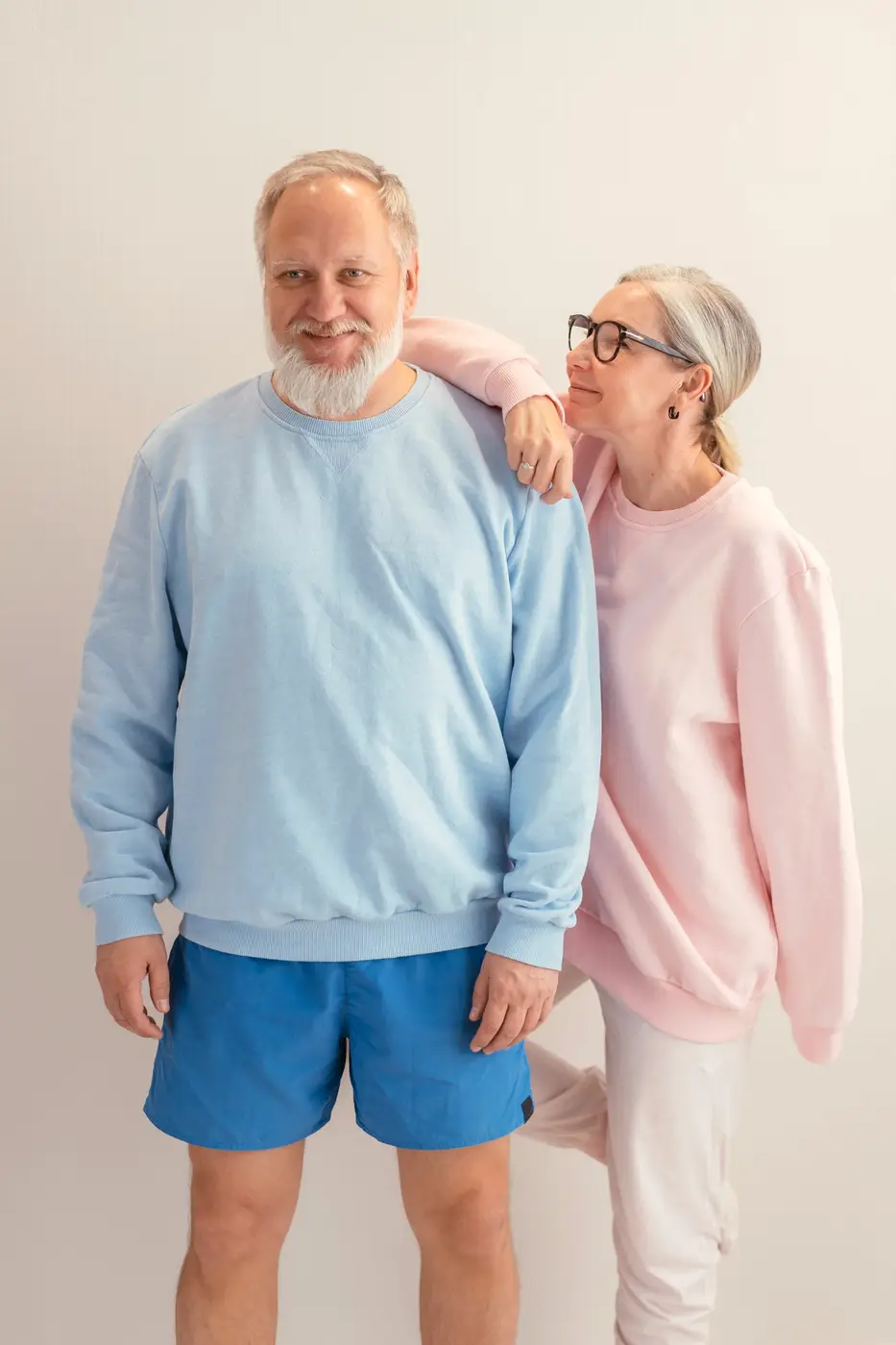 Smiling older couple in casual sweaters